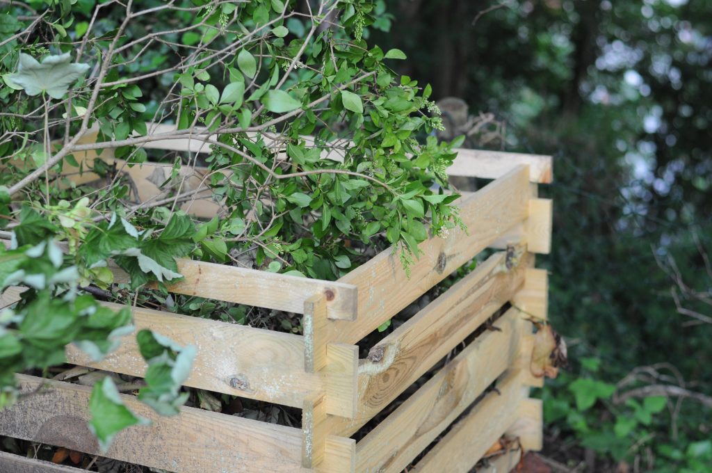 Picture showing garden waste in a wooden composter