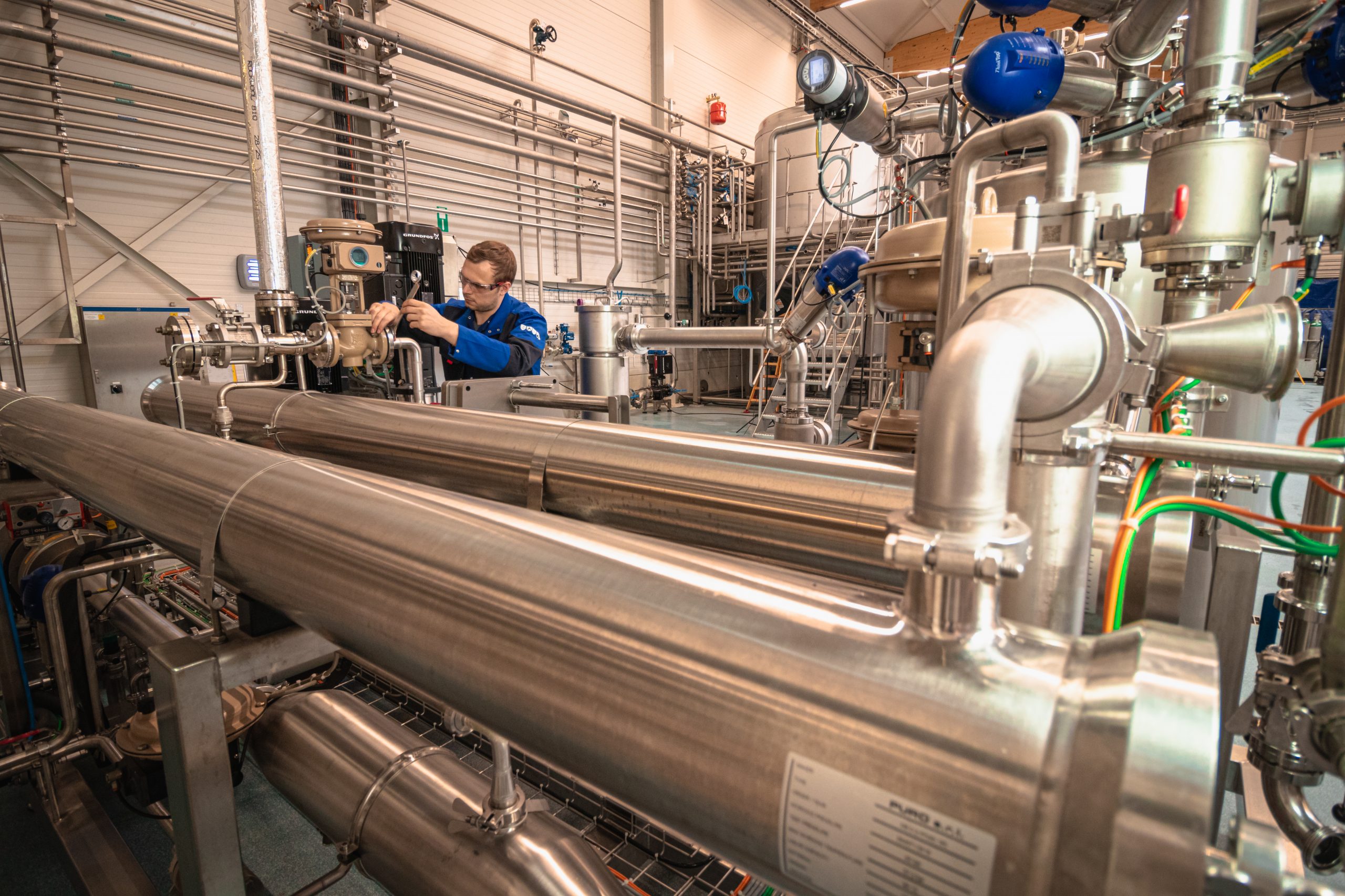 Picture showing a technician at work at a Spiral Wound Filtration Unit used for Micro-, Ultra-, Nano- and RO filtration of large volumes of fermentation broth